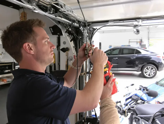 Hudson Garage Door Repair safety certified technician performing cable replacement in Hudson